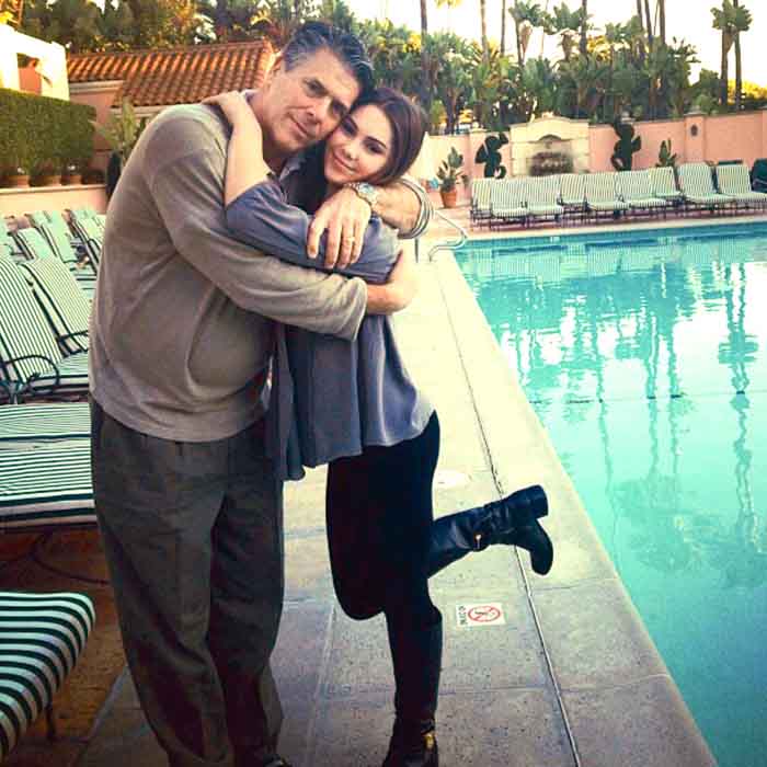 McKayala Maroney and Mike Maroney poses for a picture hugging one another.